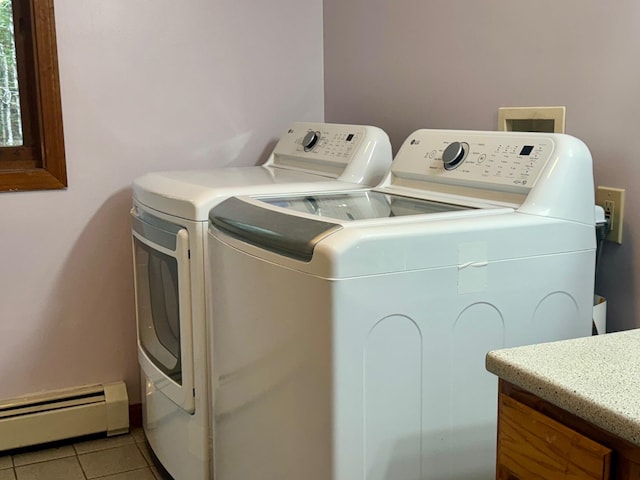 laundry area featuring washer and clothes dryer, light tile patterned flooring, and a baseboard heating unit