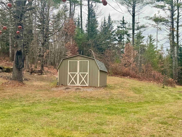 view of outdoor structure featuring a lawn