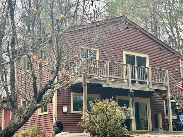 rear view of property featuring a balcony