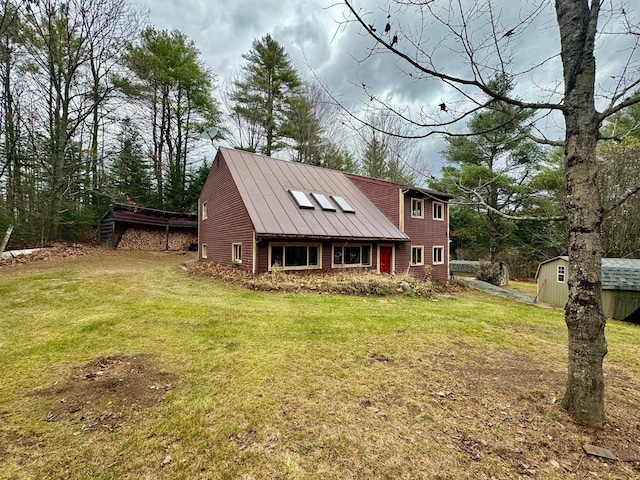 view of front of house with a front yard and a storage shed