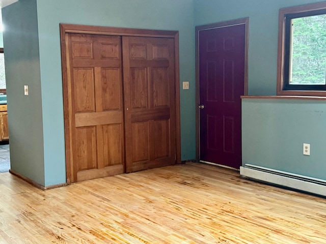 interior space with baseboard heating and light wood-type flooring