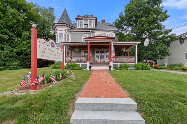 view of front of home with a porch and a front lawn