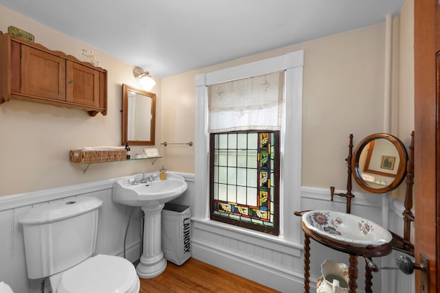 bathroom featuring hardwood / wood-style flooring and toilet