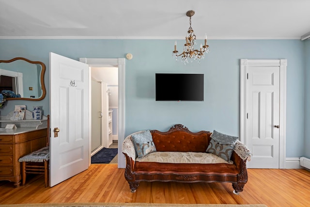 living room with ornamental molding, wood-type flooring, and an inviting chandelier