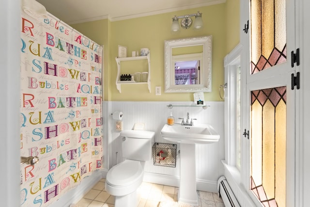 bathroom featuring tile patterned floors, crown molding, a shower with shower curtain, a baseboard heating unit, and toilet