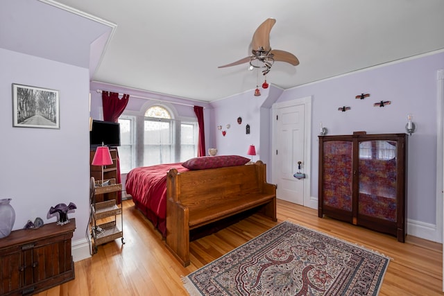 bedroom with light wood-type flooring and ceiling fan