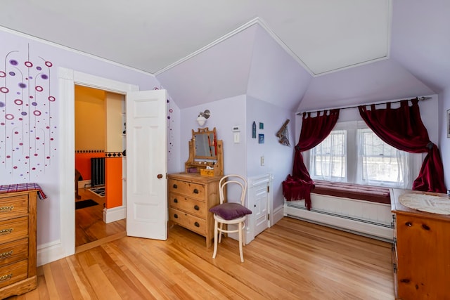 bedroom featuring a baseboard radiator, light hardwood / wood-style flooring, and lofted ceiling