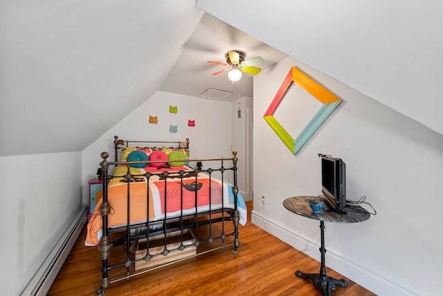 bedroom with baseboard heating, hardwood / wood-style floors, ceiling fan, and vaulted ceiling