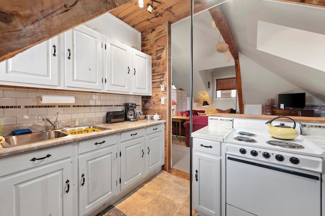 kitchen featuring tasteful backsplash, white cabinetry, sink, and white electric range