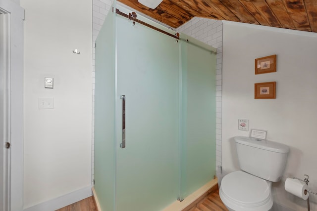 bathroom with hardwood / wood-style floors, wood ceiling, lofted ceiling, a shower with shower door, and toilet