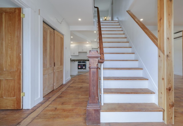 stairway featuring hardwood / wood-style flooring