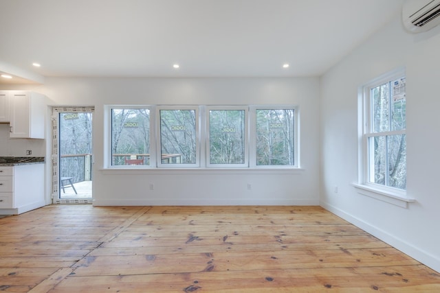 unfurnished living room with a wealth of natural light and light wood-type flooring