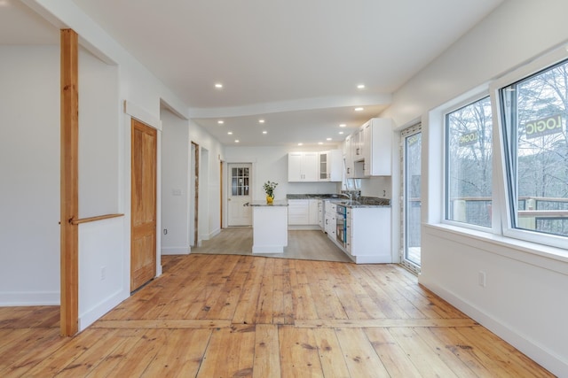 kitchen featuring white cabinetry, light hardwood / wood-style floors, and sink