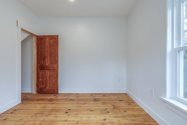 empty room with light hardwood / wood-style flooring