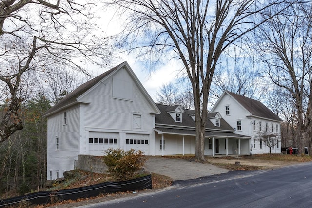 view of front facade with a garage and a porch