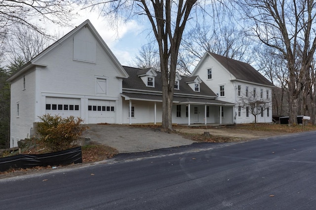 view of front of property featuring a garage and a porch