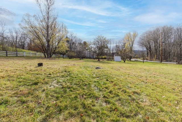 view of yard featuring a storage shed and a rural view