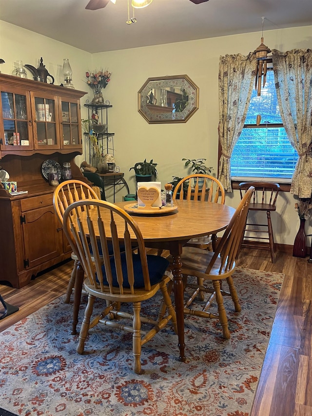 dining area featuring ceiling fan and dark hardwood / wood-style flooring