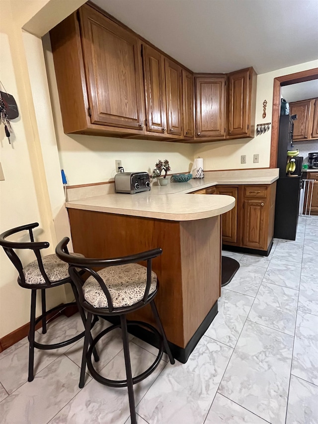 kitchen with a kitchen bar and kitchen peninsula