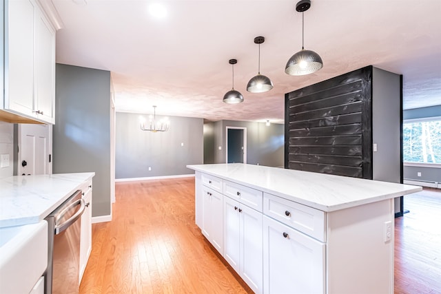 kitchen featuring stainless steel dishwasher, white cabinetry, and light wood-type flooring