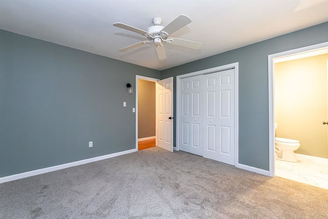 unfurnished bedroom featuring ceiling fan, connected bathroom, light carpet, and a closet