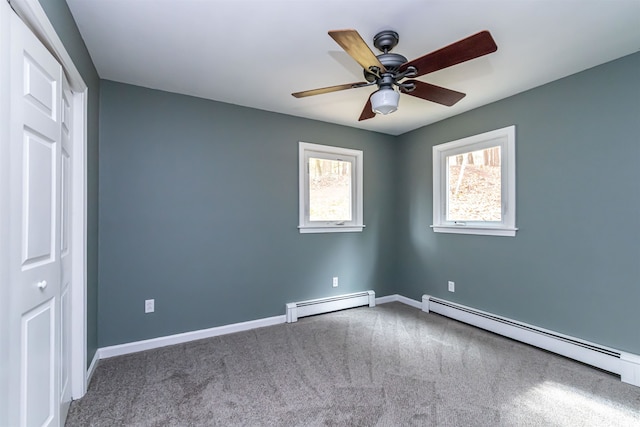 unfurnished bedroom with a baseboard radiator, carpet floors, and ceiling fan