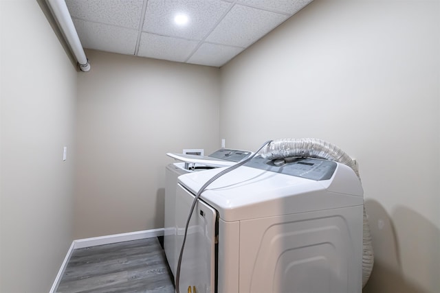 washroom featuring hardwood / wood-style floors and washer and dryer