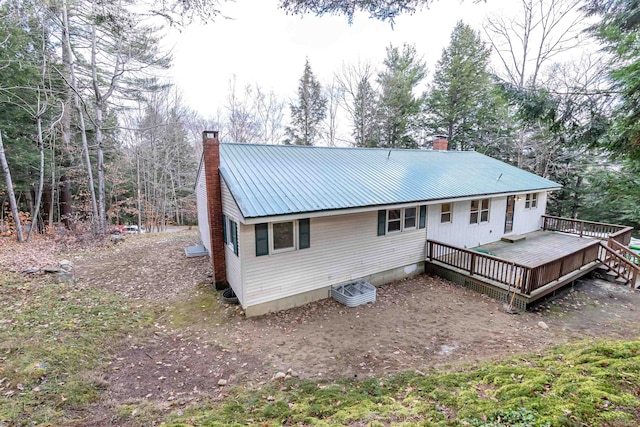 rear view of property with a wooden deck