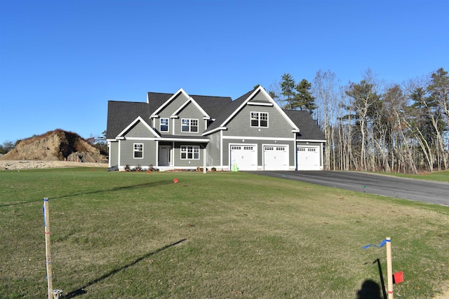 craftsman-style home with a garage and a front lawn