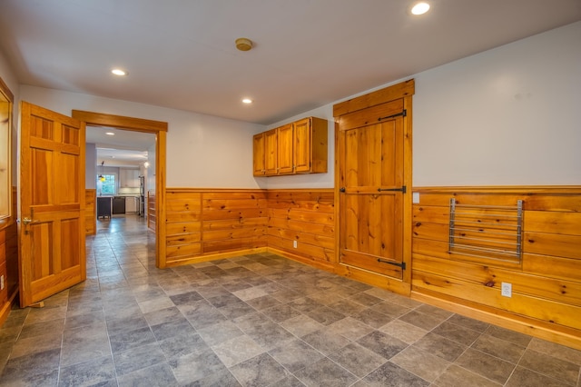 spare room with wooden walls