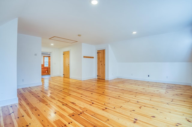 interior space with light hardwood / wood-style floors and lofted ceiling