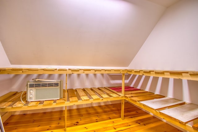 interior space featuring wood-type flooring and vaulted ceiling