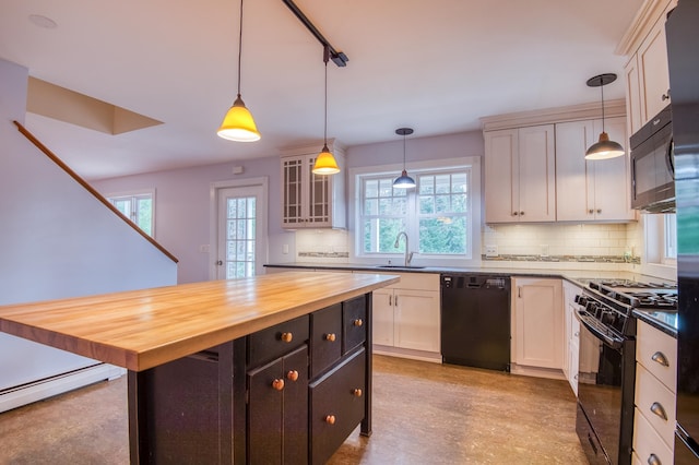 kitchen with butcher block countertops, white cabinets, hanging light fixtures, and black appliances