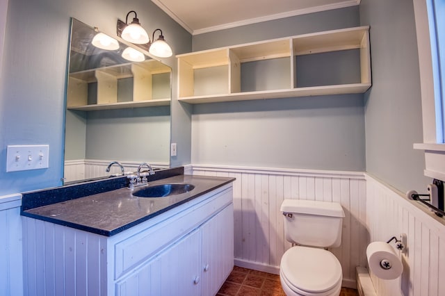 bathroom with toilet, vanity, and crown molding