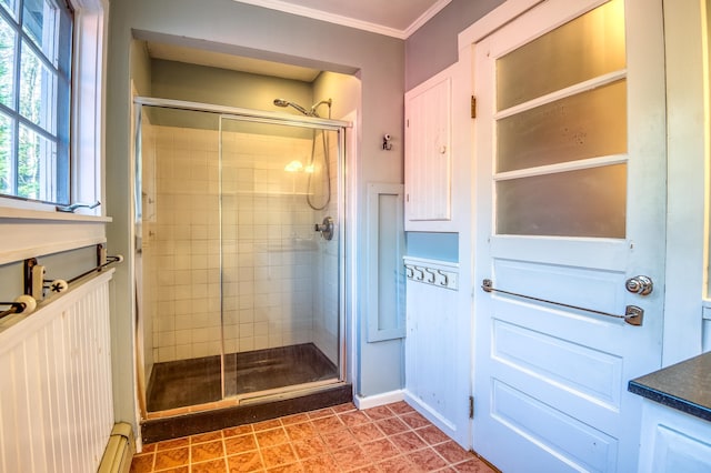 bathroom featuring baseboard heating, ornamental molding, and an enclosed shower