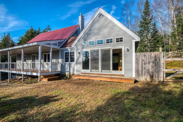 rear view of property with a lawn and covered porch