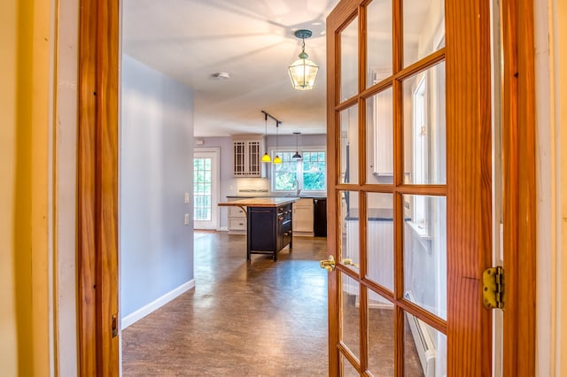 hallway with baseboard heating and french doors