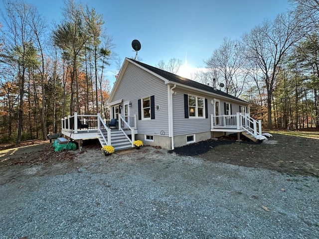 view of front facade with a wooden deck