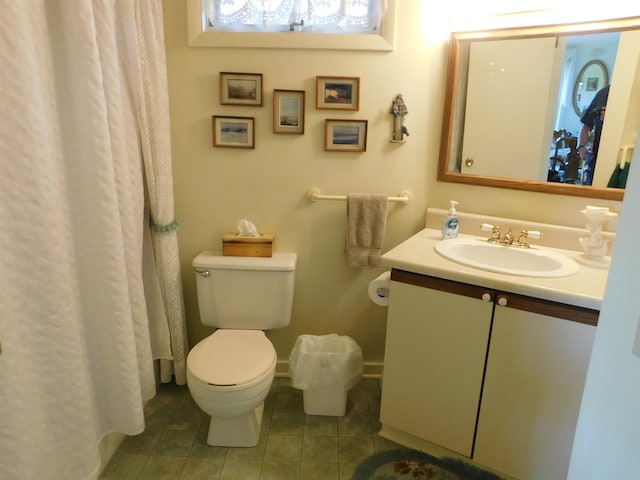 bathroom with tile patterned flooring, vanity, and toilet