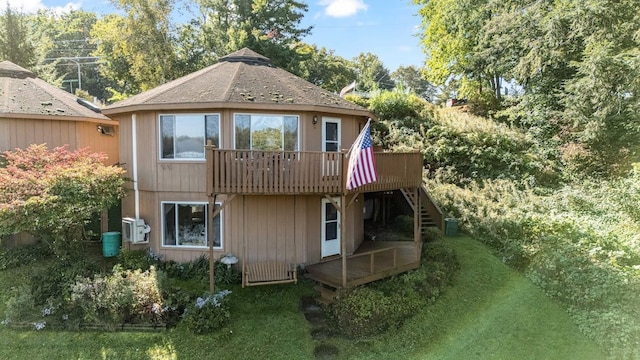 back of property featuring a wooden deck