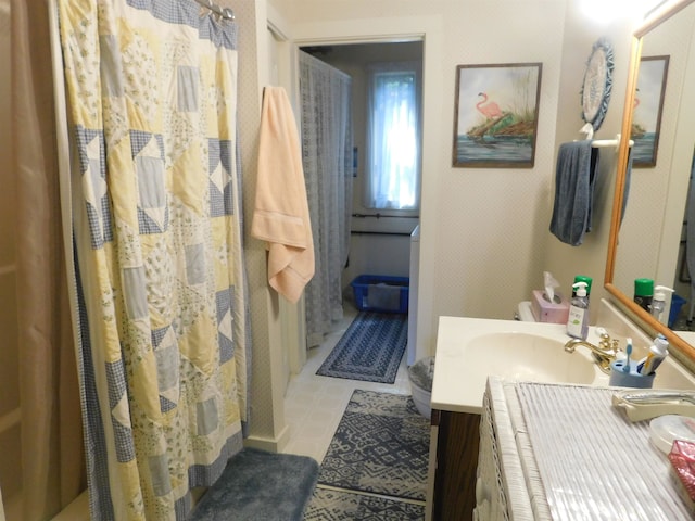 bathroom featuring curtained shower, vanity, and tile patterned floors