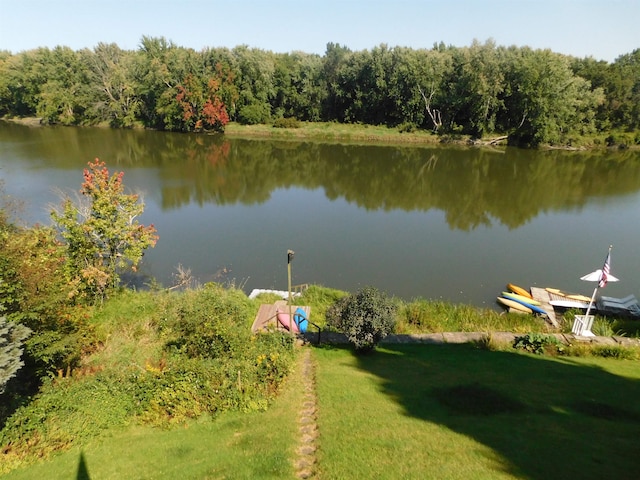 exterior space featuring a water view and a yard