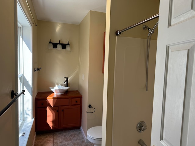 bathroom with toilet, bathing tub / shower combination, and tile patterned floors