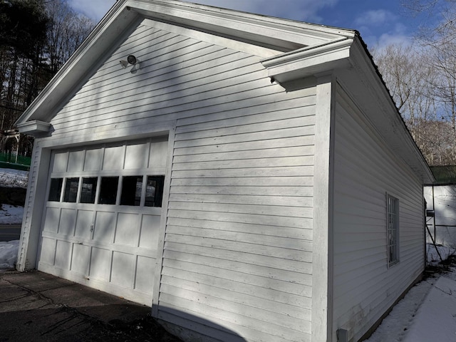 view of side of home featuring a garage and an outdoor structure