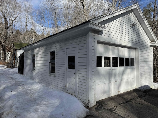 view of side of home featuring an outbuilding