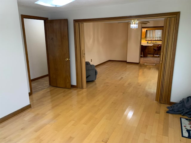 spare room with light hardwood / wood-style floors and ceiling fan