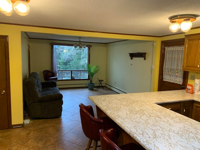 dining space featuring tile patterned flooring, a notable chandelier, a textured ceiling, and crown molding