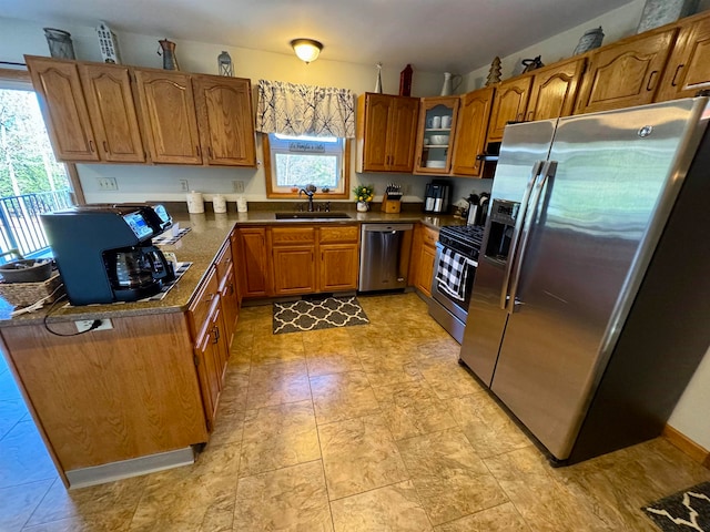 kitchen with a wealth of natural light, appliances with stainless steel finishes, and sink