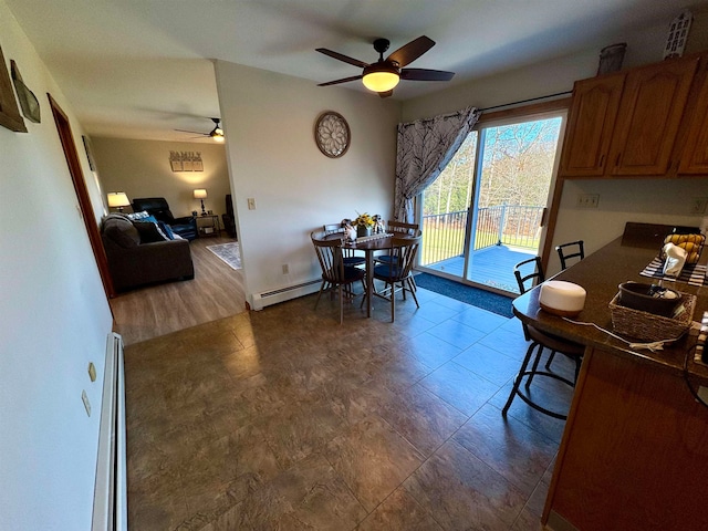 dining area with baseboard heating and ceiling fan