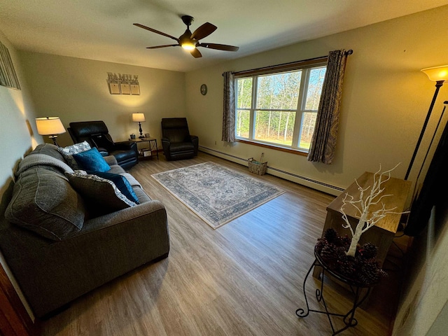 living room with baseboard heating, hardwood / wood-style floors, and ceiling fan